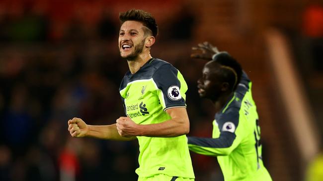 Adam Lallana of Liverpol (L) celebrates scoring.