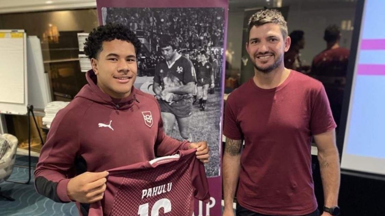 Josiah Pahulu receiving his jersey from Broncos and Maroon legend Matt Gillett.