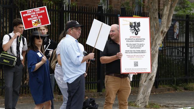 At least 30 parents and ex-students held placards and signs against Newington’s decision.