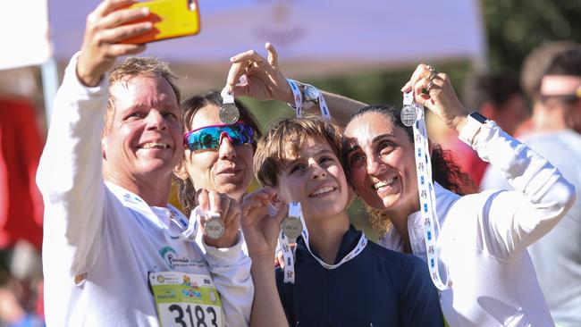 Richard Hardwick from Bilgola, his sister in law, Maria Geracitano from Elizabeth Bay; his son Ethan, 11, and wife Franca taking a selfie with their medals in 2017. Picture: Julian Andrews