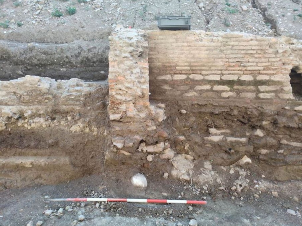 The head was found in the foundations of this wall. Picture: Roma Press Office/ CNN