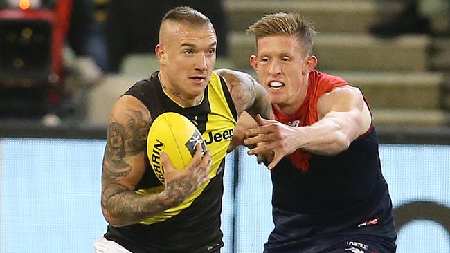 Richmond star Dustin Martin brushes off Melbourne’s Sam Frost. Picture: Michael Klein