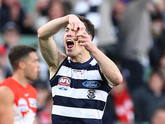 Jeremy Cameron of the Cats cracks a can to celebrate a 4th quarter goal in the grand final. Picture: Michael Klein