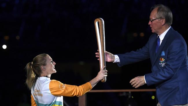 Australian hurdler Sally Pearson hands the Queen's Baton to Gold Coast Commonwealth Games Chairman Peter Beattie during the Opening Ceremony.