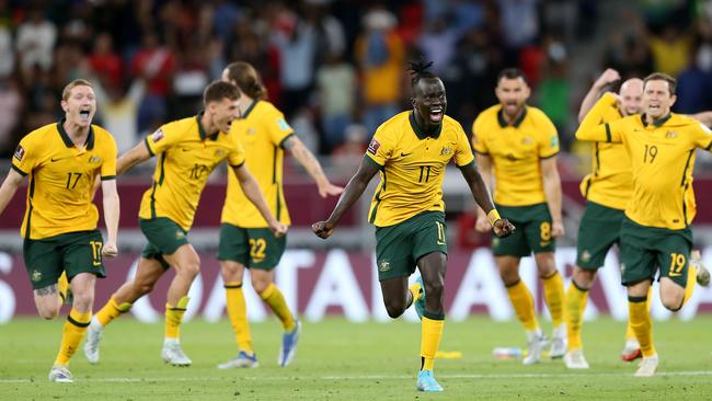 DOHA, QATAR - JUNE 13: Awer Mabil and team mates of Australia celebrate their sides victory after a penalty shoot out following the 2022 FIFA World Cup Playoff match between Australia Socceroos and Peru at Ahmad Bin Ali Stadium on June 13, 2022 in Doha, Qatar. (Photo by Mohamed Farag/Getty Images)