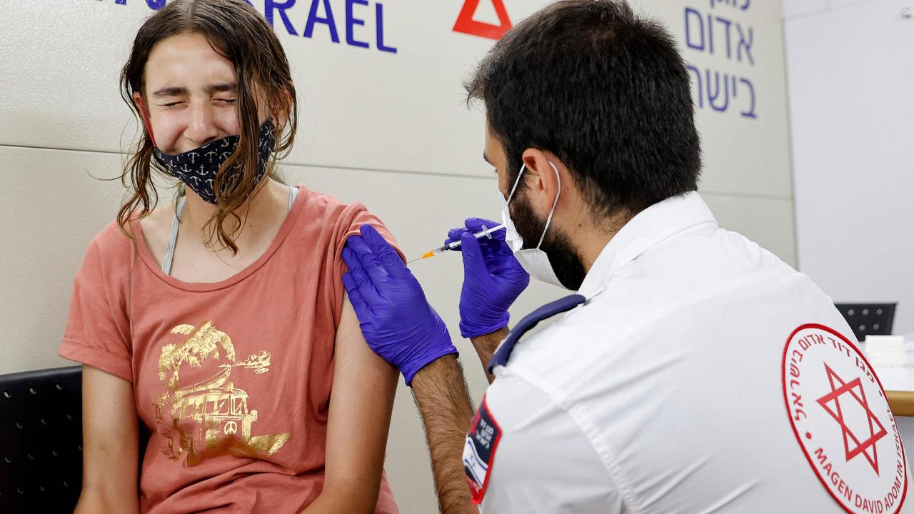 An Israeli girl receives a dose of the Pfizer/BioNTech Covid-19 vaccine from the Magen David Adom during a campaign by the Tel Aviv-Yafo Municipality to encourage the vaccination of teenagers. Picture: JACK GUEZ / AFP