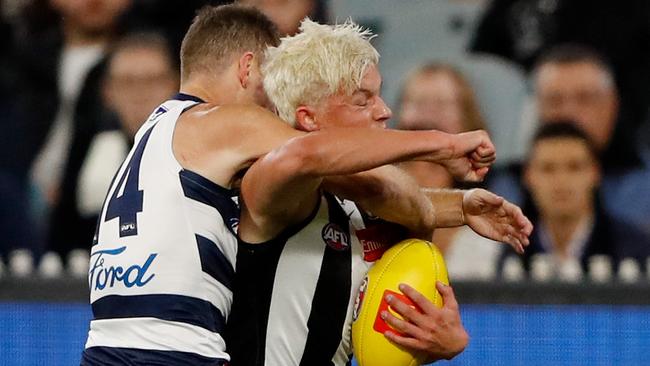 Jack Ginnivan catches with Joel Selwood.