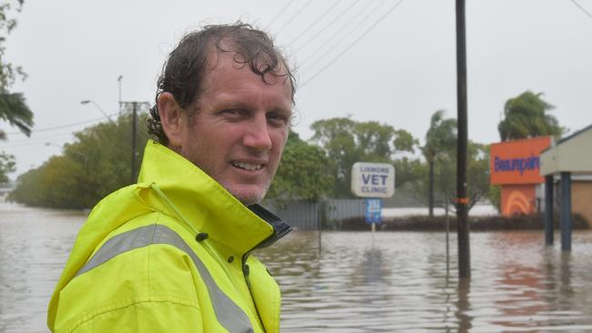 Adam Mazzarella standing on Uralba Street in Lismore watches as Beaurepaires is flooded for the second time in four weeks Picture: Nicholas Rupolo.