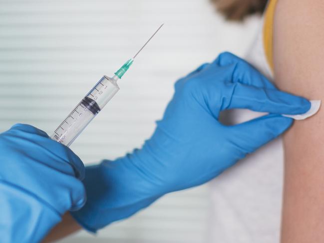 Doctor gives an injection to a patient with a disposable syringe