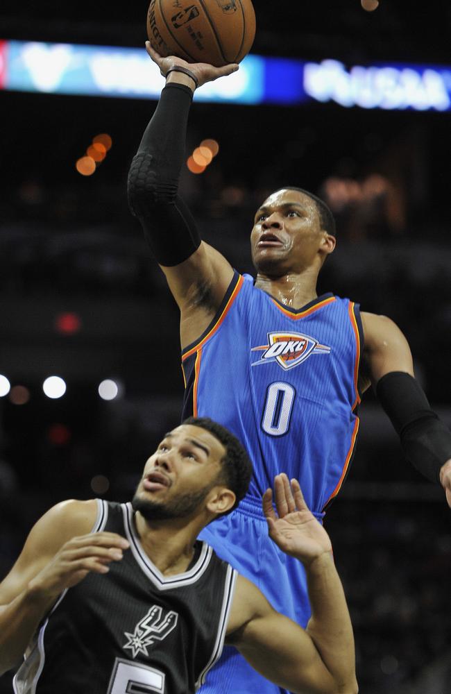 Oklahoma City Thunder guard Russell Westbrook, right, shoots over San Antonio Spurs guard Cory Joseph.