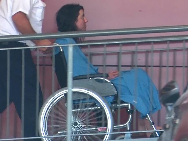 Kate Delaney is taken into Singleton Hospital by a paramedic in a wheelchair.