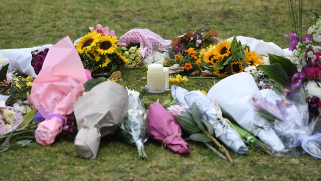 Flowers at a growing makeshift memorial for Eurydice Dixon at the Princes Park sporting precinct, Melbourne, Friday, June 15, 2018. Picture: AAP /Julian Smith.