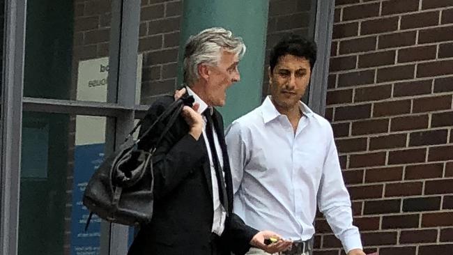 Vahid Khodabandeh leaves Burwood Local Court with his lawyer. Picture: Tony Ibrahim