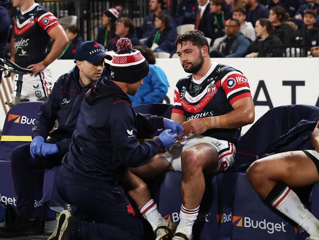 Brandon Smith of the Roosters receives attention for his broken thumb in the match against the Dragons. Picture: Getty Images