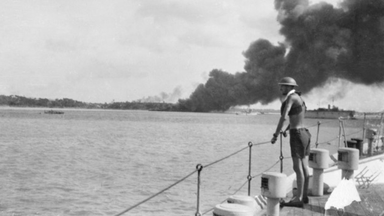 An unidentified sailor aboard the HMAS Platypus smoke rising from the destroyed MV Neptuna in the first Japanese air raid on Darwin. Photo: Australian War Memorial.