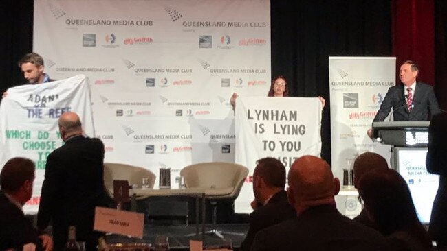 Adani protesters crash Mines Minister Anthony Lynham’s speech at the Brisbane Convention Centre.