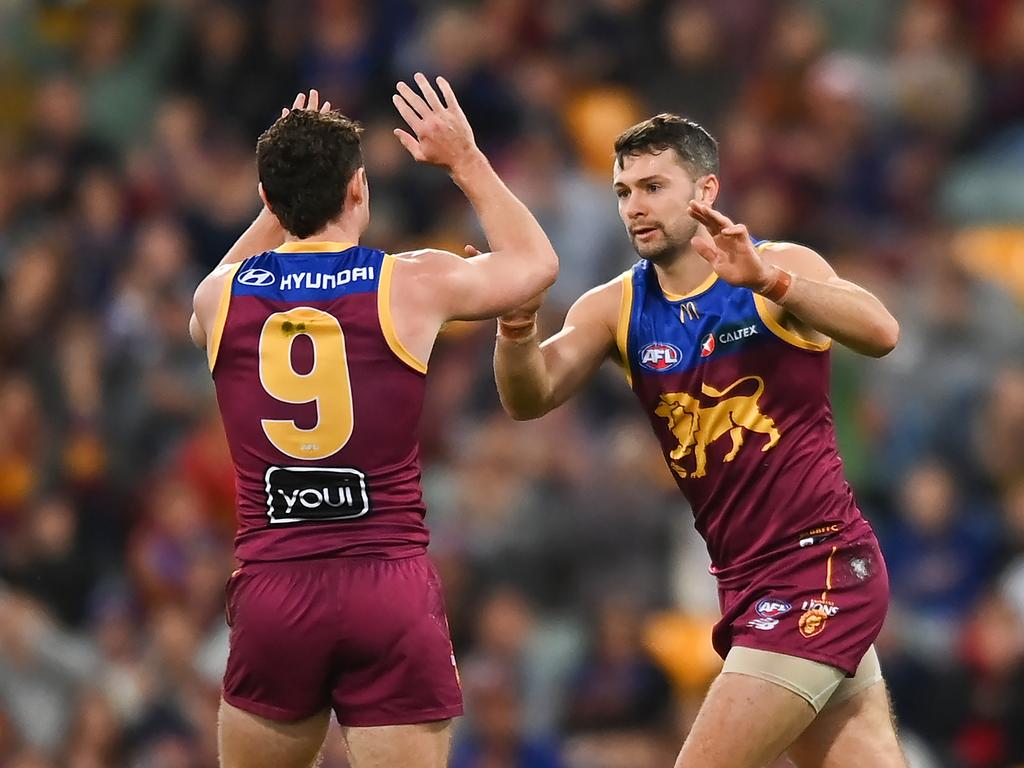 Conor McKenna (right) celebrates a goal with Lions co-captain Lachie Neale. Picture: Albert Perez/AFL Photos via Getty Images