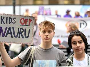 Casper, 15, and Theo, 13, during a rally at the steps of the State Library in Melbourne. Crowds supporting refugees rallied in the Sydney and Melbourne CBDs to pressure federal politicians to bring refugees from Nauru and PNG to Australia. Picture: PENNY STEPHENS