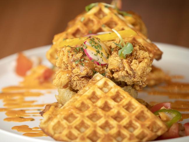 Lazy Brunch’s tasty Korean fried chicken which sits atop slightly sweet waffles drizzled with a spicy housemade sauce and pickles, makes a substantial brunch. Picture: Chris Kidd