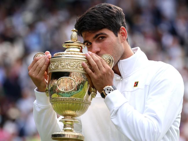 LONDON, ENGLAND - JULY 14: Carlos Alcaraz of Spain kisses the Gentlemen's Singles Trophy following victory against Novak Djokovic of Serbia in the Gentlemen's Singles Final during day fourteen of The Championships Wimbledon 2024 at All England Lawn Tennis and Croquet Club on July 14, 2024 in London, England. (Photo by Clive Brunskill/Getty Images) *** BESTPIX ***