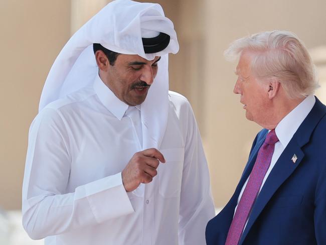 Donald Trump speaks with Emir of Qatar Tamim bin Hamad al Thani. Picture: Getty Images