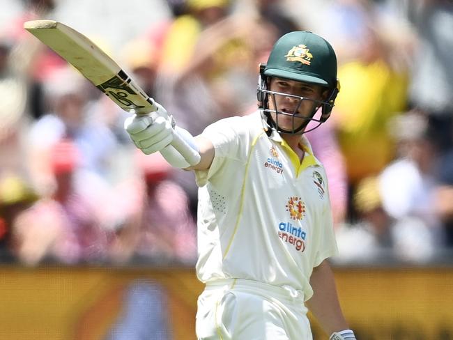 MELBOURNE, AUSTRALIA - DECEMBER 27: Marcus Harris of Australia raises his bat after scoring a half century during day two of the Third Test match in the Ashes series between Australia and England at Melbourne Cricket Ground on December 27, 2021 in Melbourne, Australia. (Photo by Quinn Rooney/Getty Images)