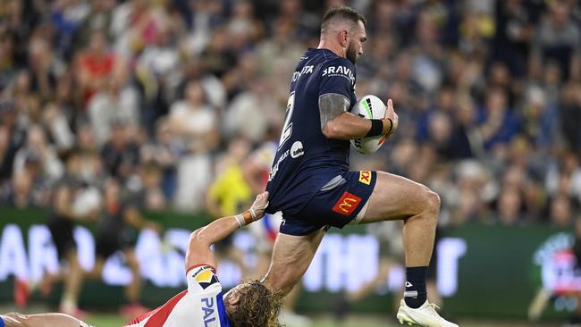 Kyle Feldt skips out of a tackle by Phoenix Crossland of the Knights. (Photo by Ian Hitchcock/Getty Images)