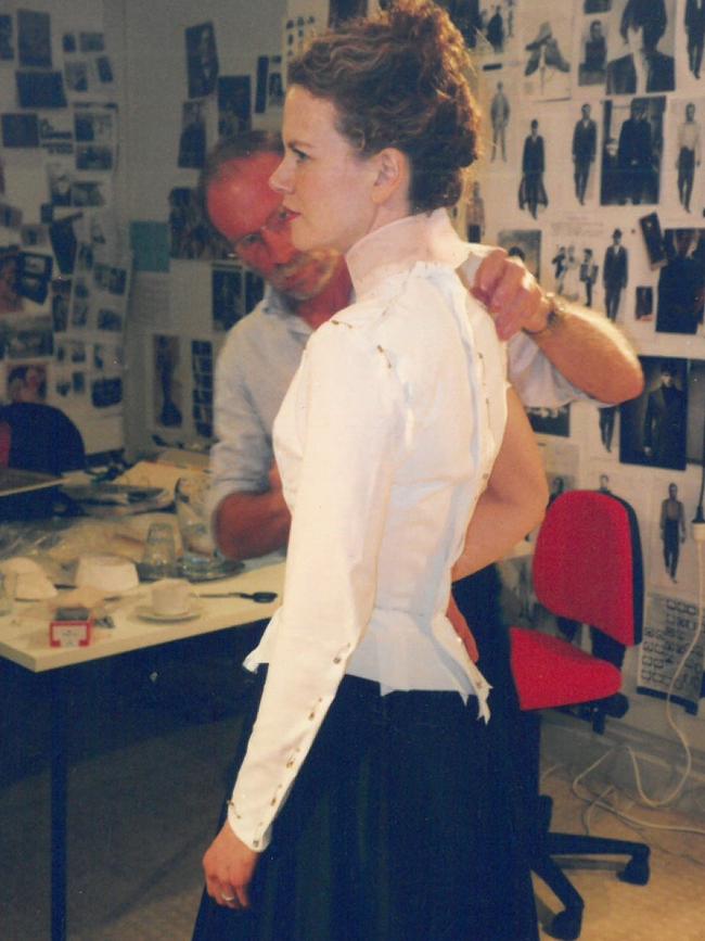 Launceston corset maker Anthony Phillips painstakingly pins Nicole Kidman into one of her outfits for Moulin Rouge, in 2000. Picture: Supplied