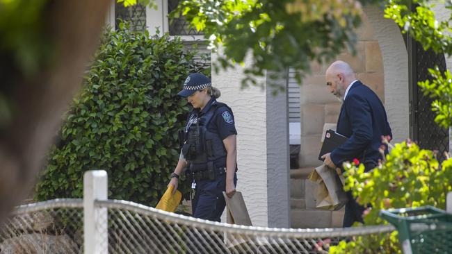 Police and detectives are seen leaving with evidence. Picture: RoyVPhotography