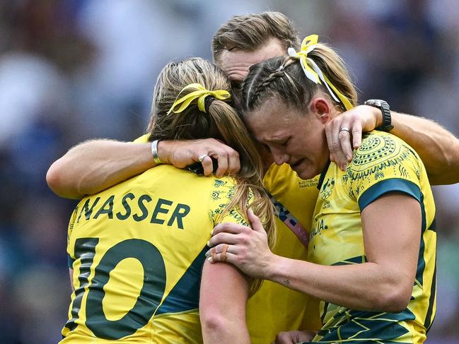 TOPSHOT - Australia's Maddison Levi (R) and Australia's Isabella Nasser (L) react after the women's semi-final rugby sevens match between Canada and Australia during the Paris 2024 Olympic Games at the Stade de France in Saint-Denis on July 30, 2024. (Photo by CARL DE SOUZA / AFP)