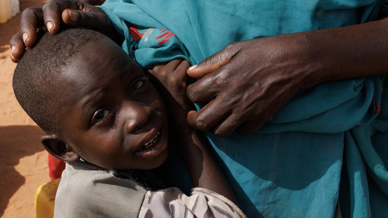 A young child cries while waiting in line for water at Ourang refugee camp in Adre, Chad on April 20. Picture: Dan Kitwood/Getty Images