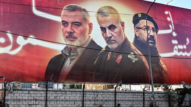 A giant billboard in Beirut showing pictures of slain Palestinian Hamas political leader Ismail Haniyeh, Iran's Islamic Revolutionary Guard Corps' commander Qasem Soleimani, and Lebanese Hezbollah's commander Fuak Shukr. Picture: Joseph Eid / AFP