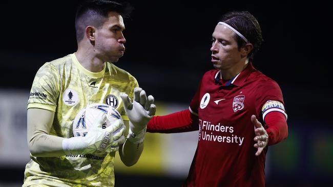 MELBOURNE, AUSTRALIA - AUGUST 14: Northcote City goalkeeper Brandon Cuminao and Craig Goodwin of Adelaide United contest the ball during the round of 32 2023 Australia Cup match between Northcote City FC and Adelaide United at John Cain Memorial Park, on August 14, 2023 in Melbourne, Australia. (Photo by Daniel Pockett/Getty Images)