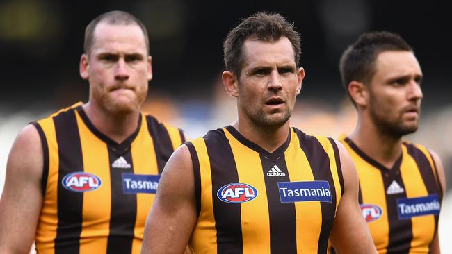 MELBOURNE, AUSTRALIA — APRIL 01: Jarryd Roughead, Luke Hodge and Jack Gunston of the Hawks looks dejected after losing the round two AFL match between the Hawthorn Hawks and the Adelaide Crows at Melbourne Cricket Ground on April 1, 2017 in Melbourne, Australia. (Photo by Quinn Rooney/Getty Images)