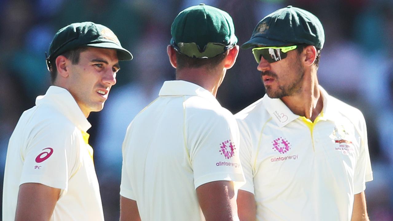 Australia's bowlers Pat Cummins, Josh Hazlewood and Mitchell Starc leave the field after India declared their innings.