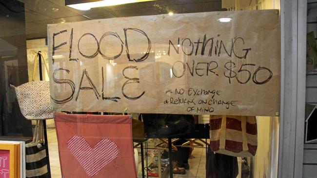 Open for business and sales notices  are a welcome sign for many in Lismore's CBD after the floods. Picture: Alison Paterson