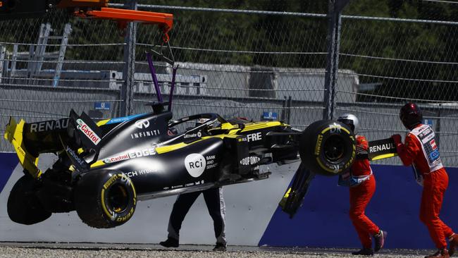 Daniel Ricciardo’s car is taken away for repairs after his crash in Austria