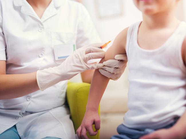 Pediatrician makes vaccination to small boy