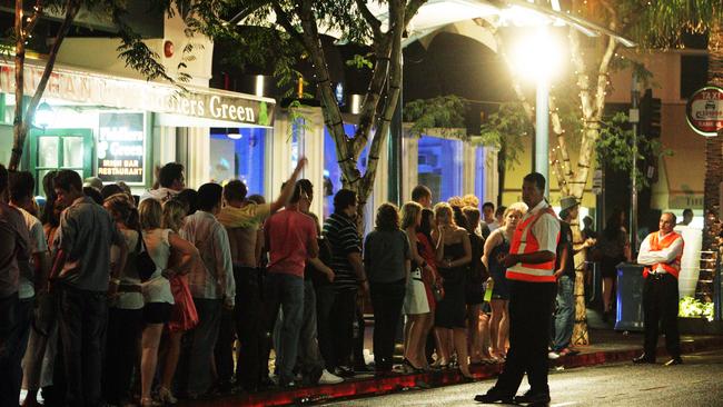 Revellers wait to catch a taxi to go home from Cavill Avenue.