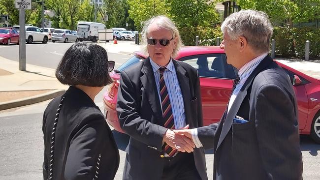 Roger Uren, centre, thanks his legal team leaves the ACT Magistrates Court. Picture: Craig Dunlop