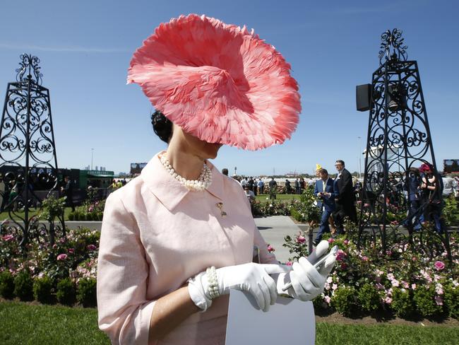 2015 Melbourne Cup Day at Flemington Racecourse. Myer Fashion in the Field. Angela McCormick wearing a Julie Casey hat checks her phone while in line for judging. Picture: David Caird.