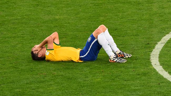 A dejected Oscar about Brazil’s 7-1 World Cup semi-final loss to Germany in front of home fans. Picture: Getty Images