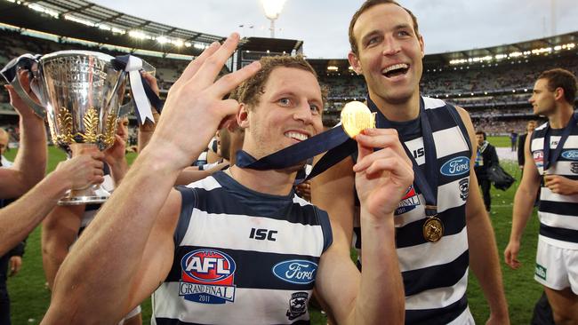 James Kelly and Brad Ottens celebrate Geelong’s 2011 premiership.