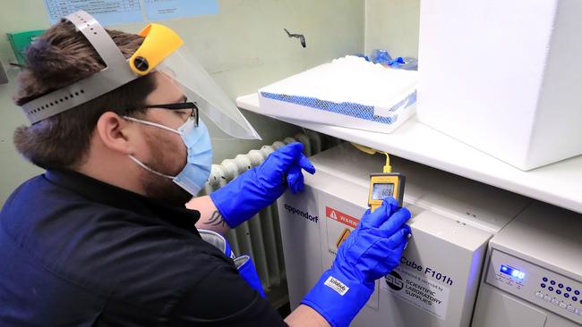 A pharmacy technician takes delivery of the first batch of COVID-19 vaccinations at Croydon University Hospital in south London. Picture: AFP