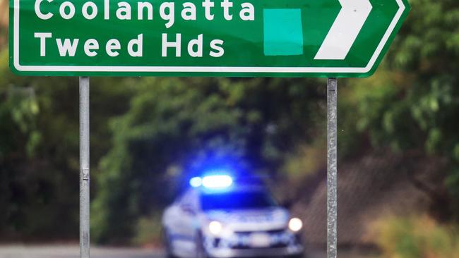 A Queensland Police car sits on the border of NSW and Queensland on the M1 Highway at Bilinga outside the airport. Photo: Scott Powick.