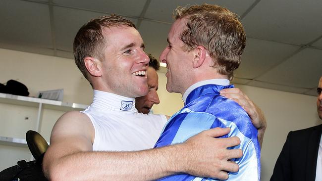 Tommy Berry (left) hugs twin brother Nathan after Nathan’s victory aboard Unencumbered in the 2014 Magic Millions. Picture: Adam Head