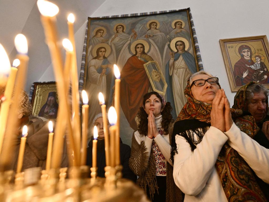 Worshippers pray during the Christmas service in a church of the Orthodox Church of Ukraine in Kyiv on December 25 amid the Russian invasion of Ukraine. Picture: AFP