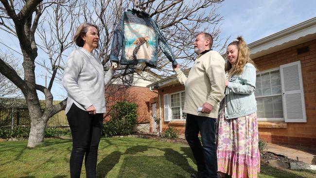 Debra and Greg Ireland, and their daughter Maddie, with the art project that is now a precious memento of Chelsea’s passion for the environment. Picture: Tait Schmaal