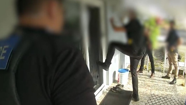 Police footage shows an officer breaking down the front door of a home during raids targeting alleged members and associates of the Mongols Outlaw Motorcycle Gang in Cairns.