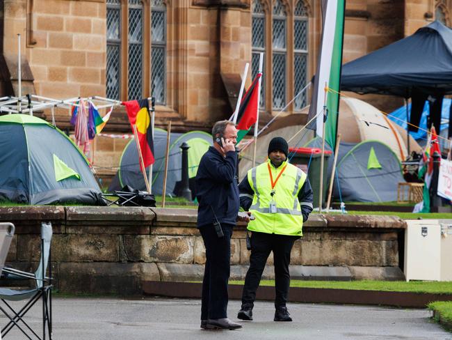 SYDNEY, AUSTRALIA - NewsWire Photos JUNE 15 2024. Security patrol a pro-gaza & Palestine tent camp on the lawn of Sydney University. The uni has ordered the pro-Palestinian encampment to pack up and leave campus eight weeks after the tent protest appeared on its lawns. Picture: NewsWire / Max Mason-Hubers